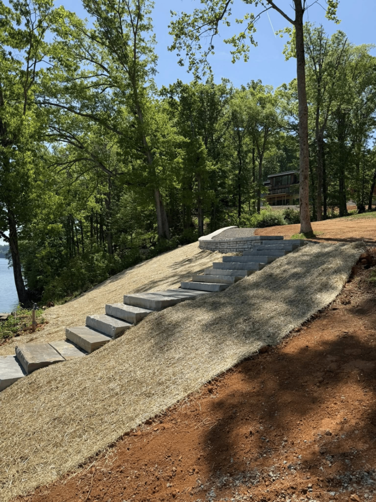 Stone stairway cut into a hillside with straw matting for erosion control